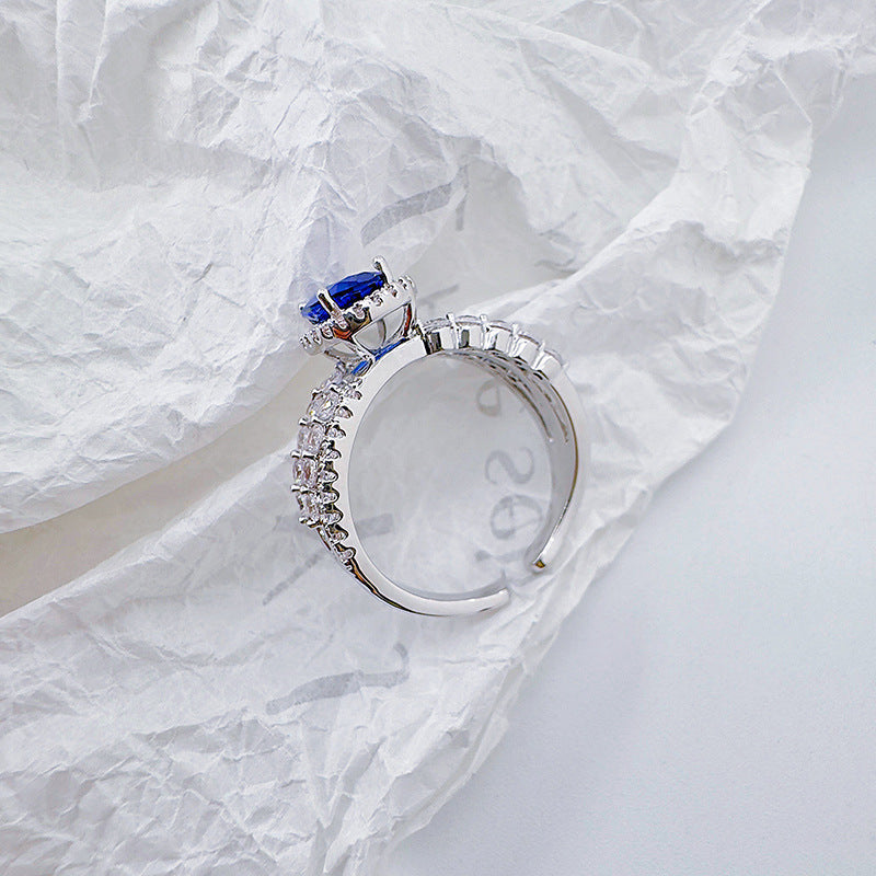 Open-end ring with blue cat's eye stones